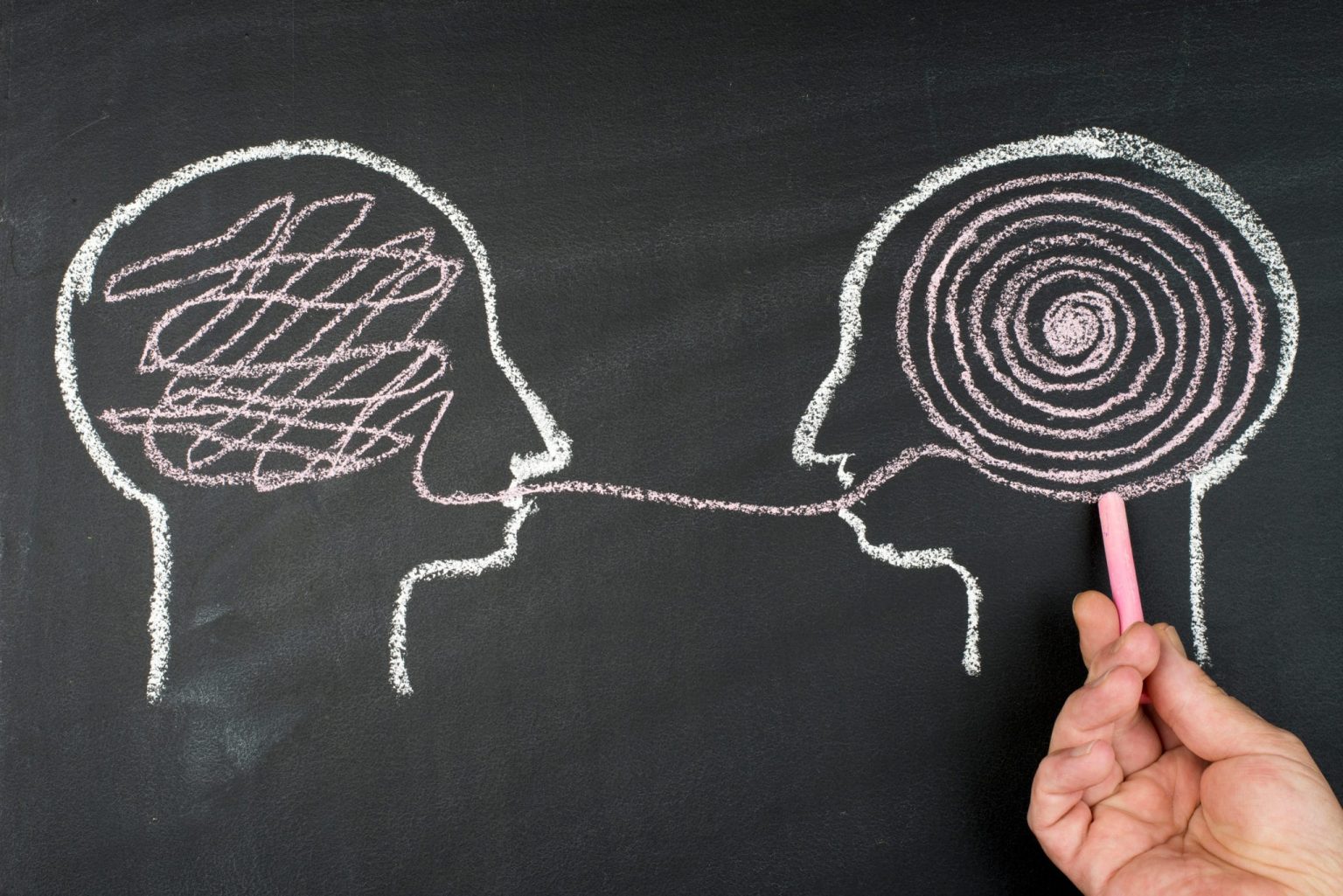 Speech-audiometry-test Chalk drawing of two heads, one with scribbles in the brain and the other with a spiral explaining a speech audiometry test.